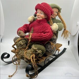 German Girl & Boy Figurines on Sled - Red & Green Holiday Christmas Winter Decor